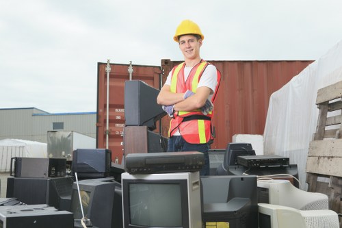 Office clearance team sorting items for recycling